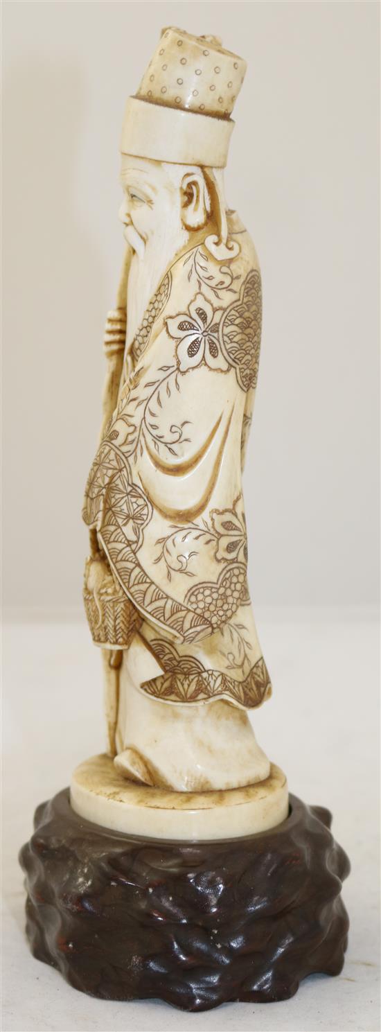 A Japanese ivory figure of a sage, early 20th century, height 25.5cm including wood stand